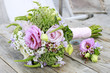 Wedding boutonniere with pink eustoma and chamelaucium flowers.