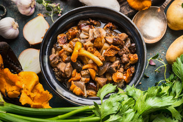 Sticker - Cooked forest mushrooms in rustic bowl with cooking ingredients, seasonal food, top view