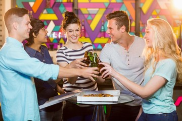 Wall Mural - Group of friends toasting bottle of beer