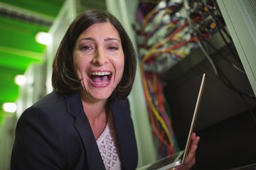 Aufkleber - Portrait of happy technician holding laptop