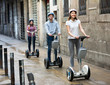 © JackF - Three friends driving segways .