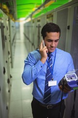 Aufkleber - Technicians talking on mobile phone while analyzing server