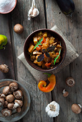 Braised eggplant with tomatoes, peppers, mushrooms and basil. Selective focus. Top view