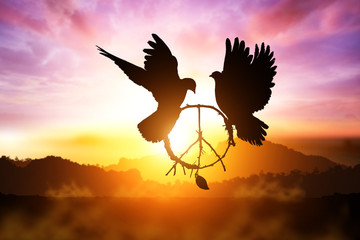 Photo Sur Toile - silhouette of pigeon dove holding branch in peace sign shape