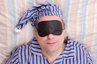 man sleeping with a mask on eyes