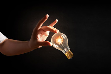 Wall Mural - hand pointing light bulb . mixed media