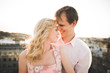 © olegparylyak - Close up portrait of happy smiling couple in love posing on roof with big balls. Landscape  city