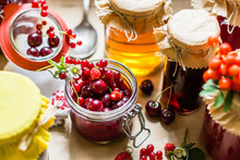 Fruit Preserves And Raw Strawberries , Cherries , Rowans Berries On A Kitchen Table, Organic Meal And Dessert Concept