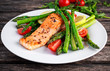 © grinchh - Fried salmon with asparagus, tomatoes, lemon, yellow lime on white plate