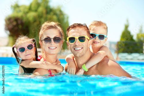 Fotografie, Obraz Happy family in swimming pool at water park