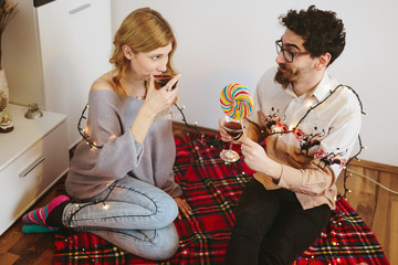 Sticker - Young couple toasting with cocktail glasses at home