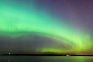 Wall Mural - northern lights over lake in finland