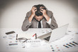 © interstid - Portrait of stressed businessman burnout holding his head with both hand at work