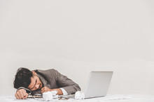 Tried Overworked Businessman Sleeping On The Office Table