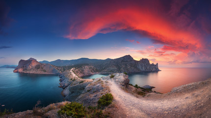 Wall Mural - Beautiful summer landscape with mountains, sea, blue sky and beautiful colorful red clouds at sunset in Crimea. Sunset in mountains. Panoramic. Nature background. Vibrant landscape in twilight. 