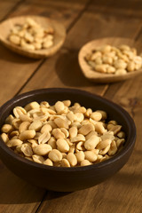 Wall Mural - Roasted peeled unsalted peanuts in rustic bowl, photographed with natural light (Selective Focus, Focus one third into the peanuts in the bowl)