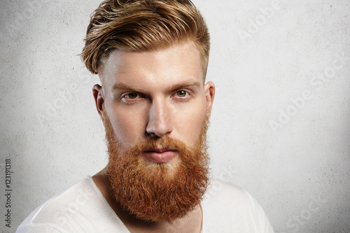 Portrait Of Young Bearded Dandy With Hair Brushed Back In A Trendy