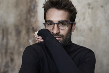 Wall Mural - Spectacled guy in black sweater, portrait