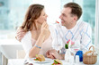 © pressmaster - A young girl sitting with her boyfriend in cafe and feeding him with a fork