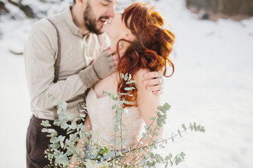 Stylish young beautiful couple of bride and groom embracing. Bac