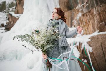 Wall Mural - Portrait of a beautiful young girl bride with a bouquet. Winter.