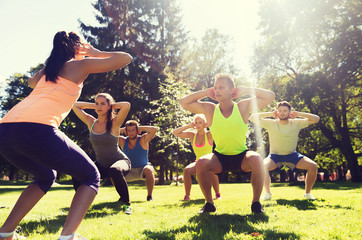 group of friends or sportsmen exercising outdoors