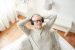 © Syda Productions - happy man in headphones listening to music at home
