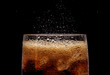 Ice cola with splashing CO bubbles.