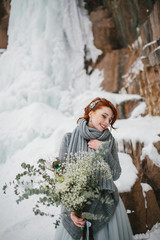 Wall Mural - Portrait of a beautiful young girl bride with a bouquet. Winter.