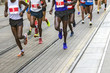 © smuki - Marathon runners race in city streets, blurred motion