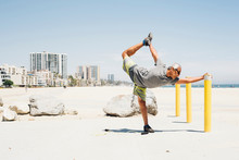 Senior Man, Exercising On Beach, Stretching Leg, Long Beach, California, USA