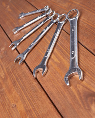 Wall Mural - Set of wrenchs chrome metal spanner instruments on wooden surface