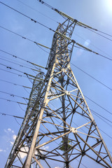 High voltage electrical overhead lines on blue sky