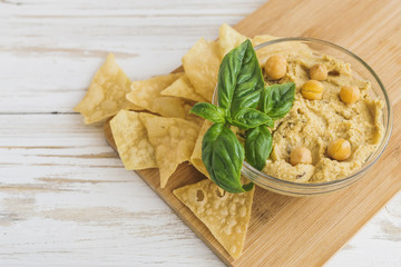 Wall Mural - Fresh homemade organic hummus with pita cheaps and basil