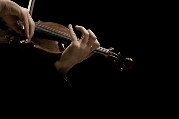 Sticker - The violin in the hands of a musician closeup on a black background