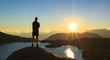 © sanderstock - Man looking over a lake, Lac Cornu, during sunset.