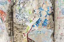 Close-up Part Of Berlin Wall. View From The West Berlin Side Of Graffiti Art On The Wall