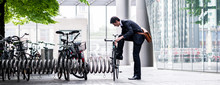 Businessman Parking His Bicycle In Town