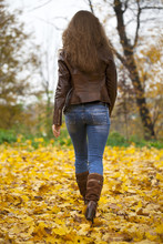 Autumn Fashion Image Of Young Woman Walking In The Park