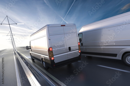 Fotografie, Obraz 3d rendering of generic vans on the road at dawn