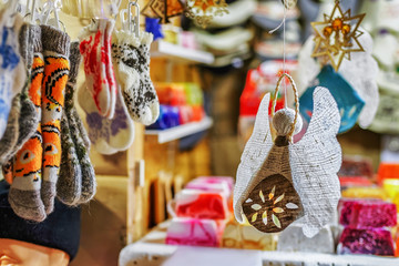 Wall Mural - Handmade linen angel and socks hanging at Riga Christmas market