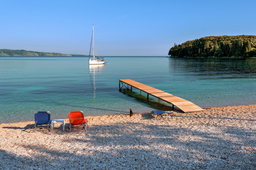 Beautiful Kalami bay - idyllic beach with crystal emerald sea water, away from the hustle and bustle of the busier towns. Very popular destination for couples and family. Corfu Island. Greece.