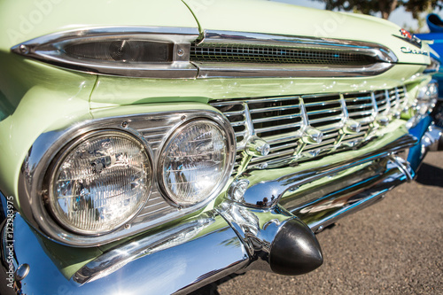 Fotografie, Obraz Part of a green classic old car with headlamp