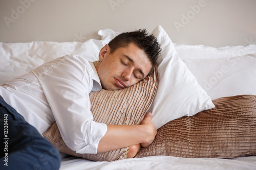 Young Man Sleeping On The Bed And Hugging A Pillow Sweet Dream Of