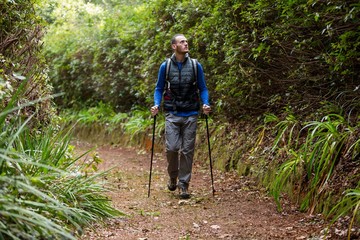 male hiker walking with hiking pole