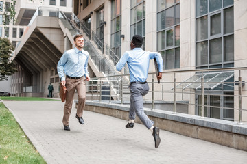 two businessmen running to meet each other