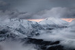 telephoto of mountains with fog and snow