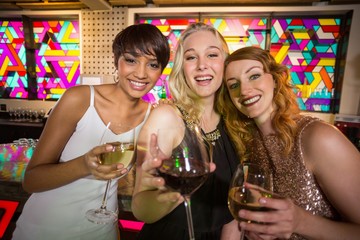 Wall Mural - Three smiling friend having glass of champagne