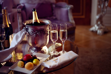 Still life, romantic dinner, two glasses and champagne in the ice bucket. Celebration or holiday