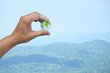 The earth in hand with blur mountain view background. The earth in your hand.